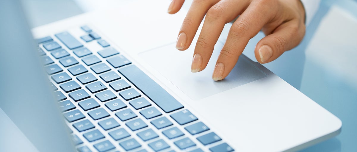 Close-up of hand woman using a laptop computer